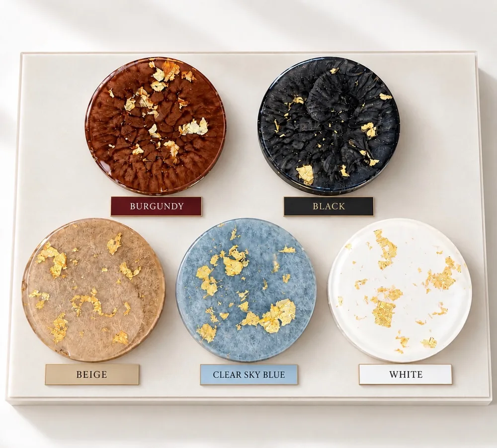 Five round acrylic plate samples with gold flakes, labelled burgundy, black, beige, clear sky blue and white