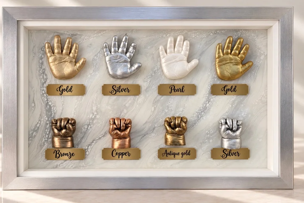 Sample hand casts in a silver frame on a marbled mat, each on a brass plate: gold, silver, pearl, gold, bronze, copper, antique gold and silver