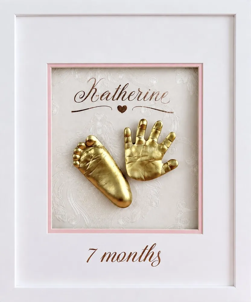 Gold cast of a baby's hand and foot on a blush mat, lettered Katherine, 7 months