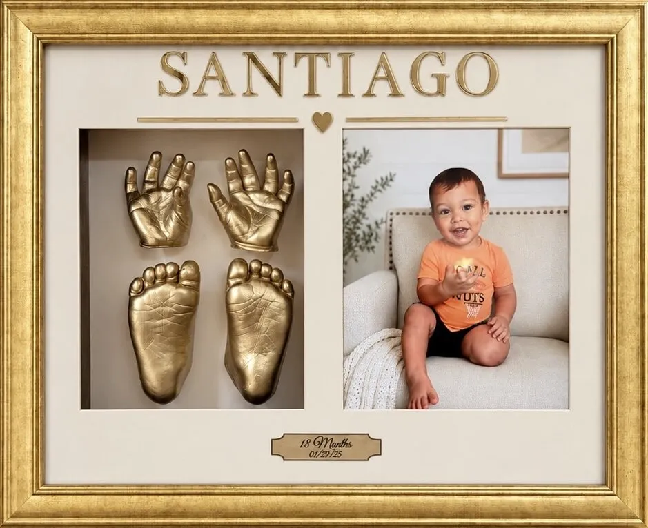 3D gold casts of a baby's hands and feet in a gold frame lettered Santiago, beside a photo of the baby