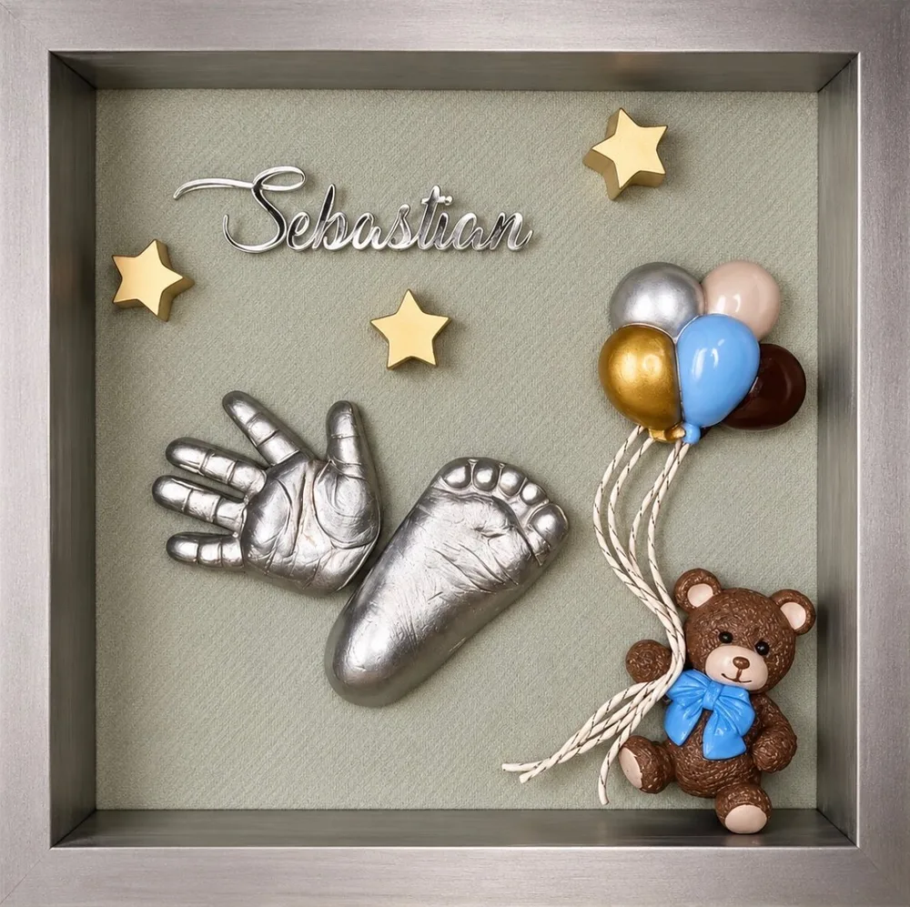 2D silver cast of a baby's hand and foot on a sage mat in a silver shadow box, lettered Sebastian, with gold stars, balloons and a teddy bear